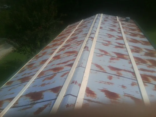 Rusted metal roof panels with new wood purlins before replacement — Storm Damage Roof Repair in Fish Haven by Roofing Brothers