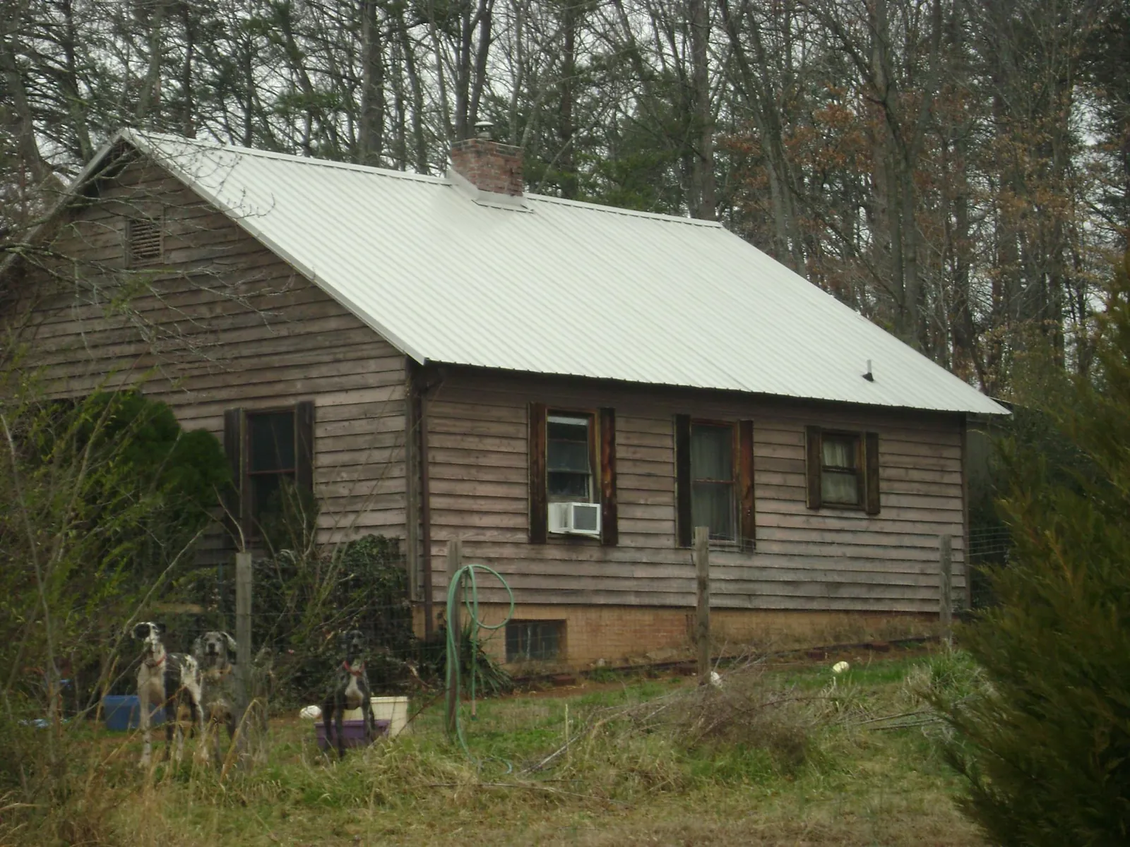 White metal roof on an old wood sided farmhouse, from a Metal Roof Installation job in Fish Haven