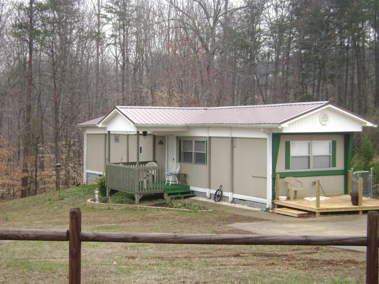 Mauve metal roof on a manufactured home with a new front deck in Fish Haven